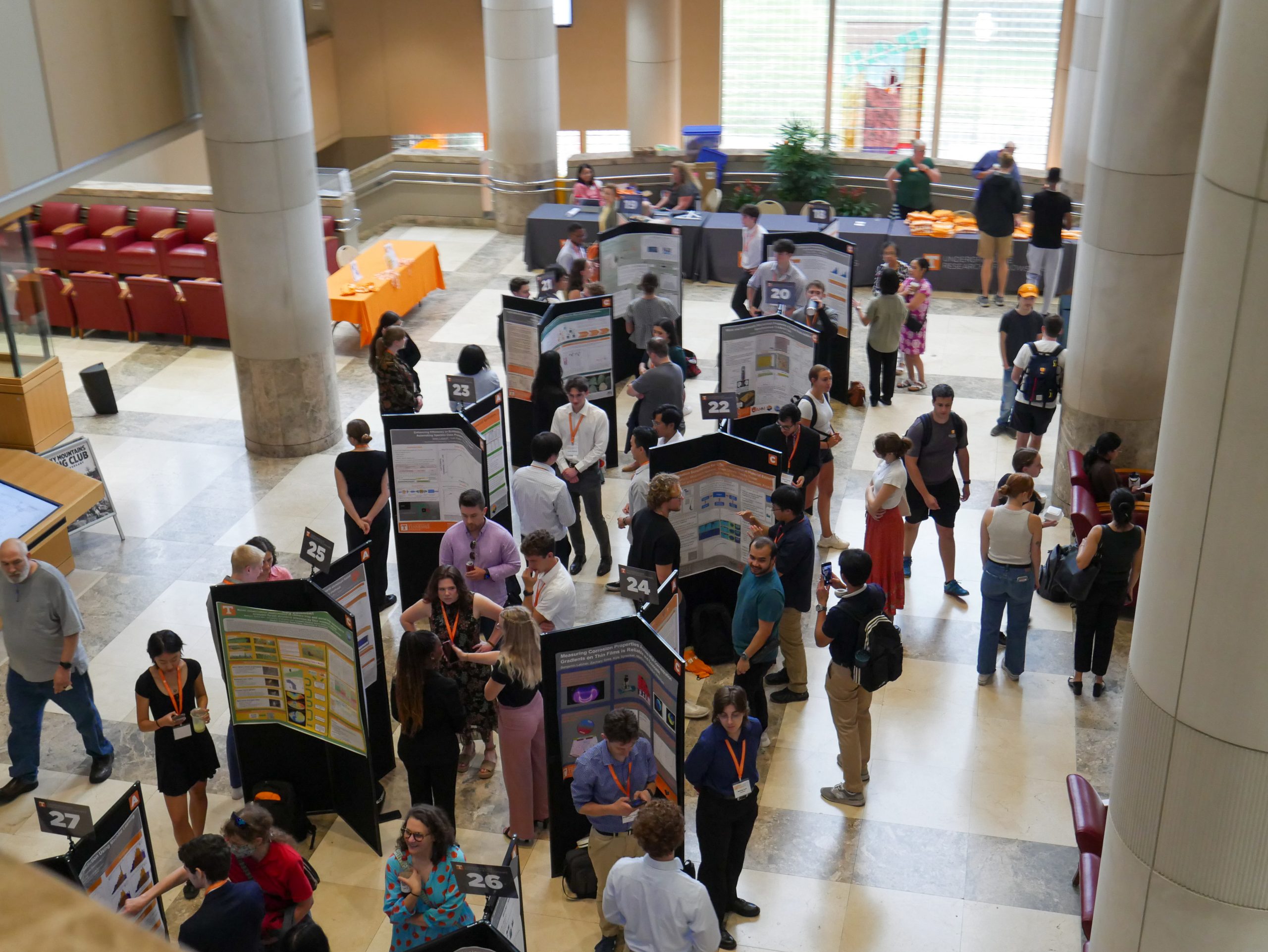 Students presenting research posters during a summer research event