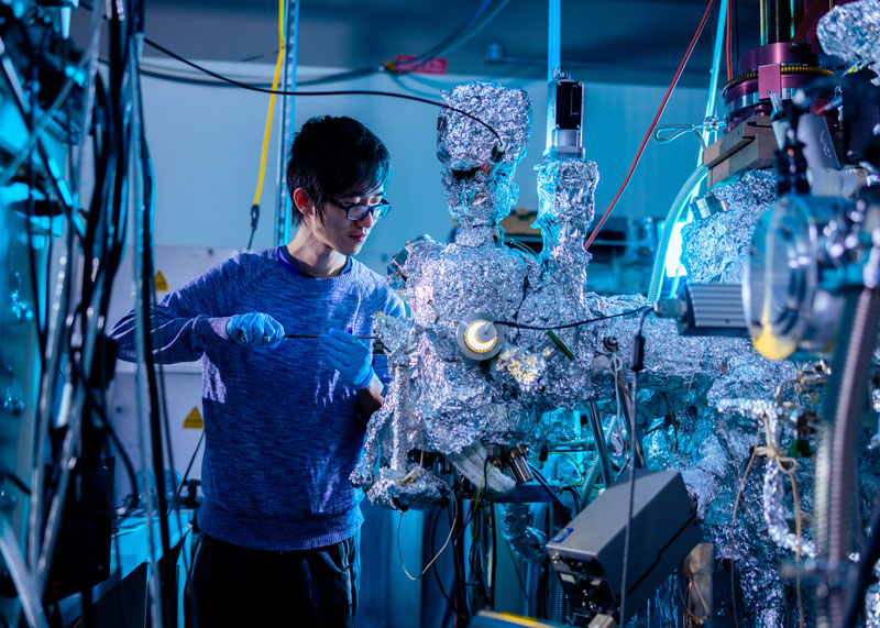 A graduate student works in the Molecular Beam Epitaxy Core Facility